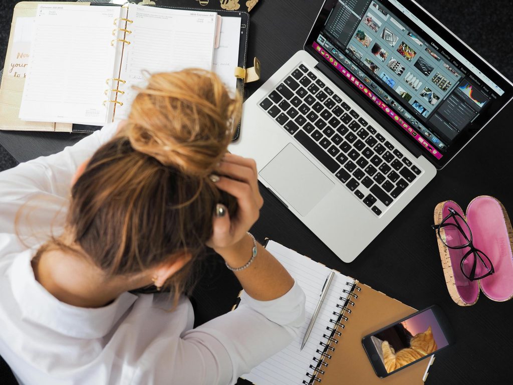 Designer looking at a layout on a laptop while trying to figure out why the design feels unfinished