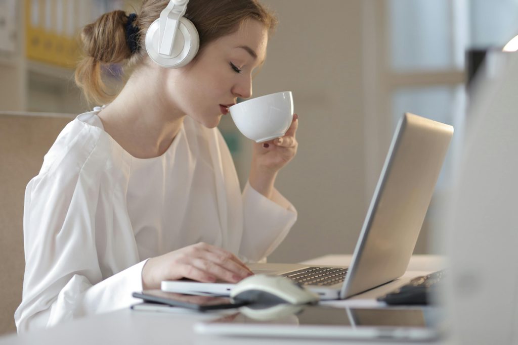 A user calmly sips a warm beverage, feeling more calm knowing when to use Canva and when to use another tool